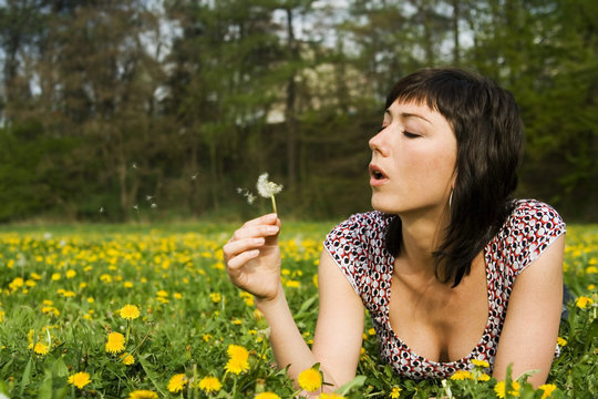 the woman in a meadow - blowing