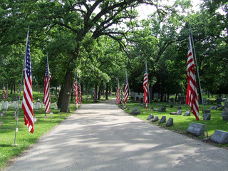 cemetary path lined with flags