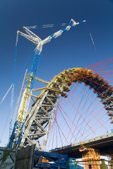crane and arch of bridge