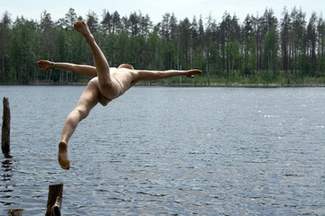 man jumping into lake
