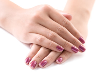 manicured female hands against white background