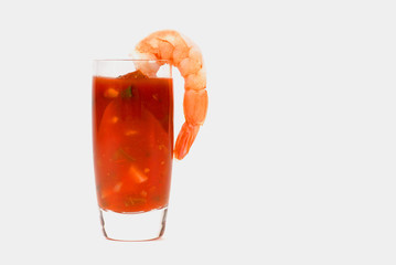 large shrimp on a glass containing cocktail sauce isolated on wh