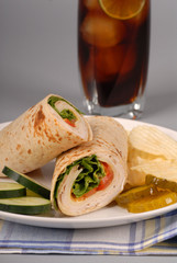 turkey and swiss cheese wrap with soft drink
