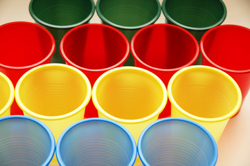plastic cups of various colours in rows