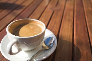 white coffee cup on wooden table