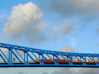 subway train on blue bridge