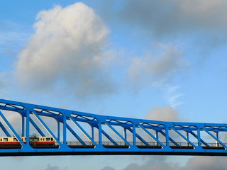 subway train on blue bridge