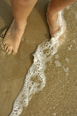 feet in the shore of the beach