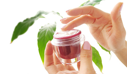 female hands with a cosmetic cream