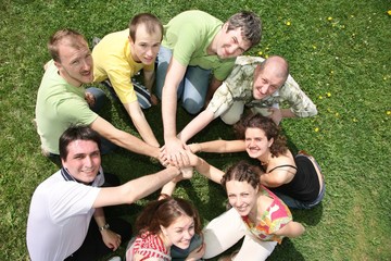 Eight friends have combined hands together