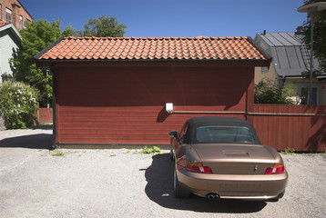 red swedish wooden house and car