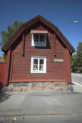 red swedish wooden house roadside