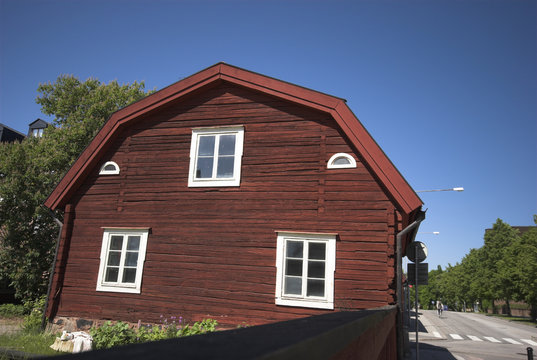 red swedish wooden house on corner