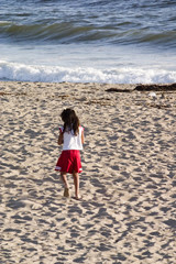 young girl playing on the beach