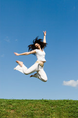 Obraz premium happy young woman is jumping