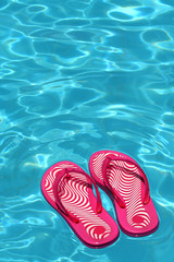 sandals by a swimming pool