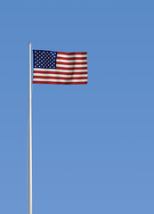 Obraz premium american flag waving on blue sky