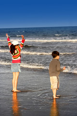 brother and sister enjoying the beach