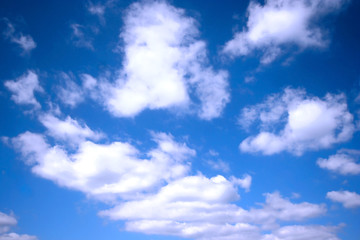 Naklejka na ściany i meble Fluffy clouds against blue sky