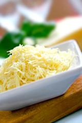 Grated cheddar cheese ready for sprinkling on dishes,.