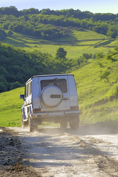 A 4X4 car on a outdoor road in a mountain region.
