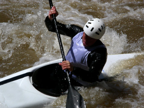 White Water Kayaker Navigating Through A Rapids