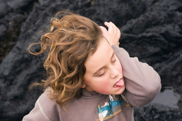 A young male tries to unsuccessfully lick his elbow