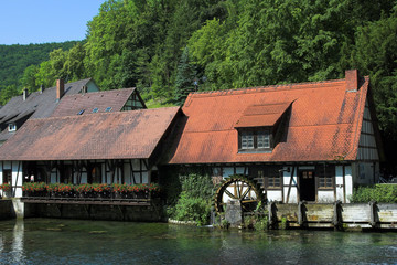 Fototapeta na wymiar Historical hammer mill at spring Blautopf Blaubeuren, Germany