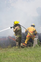 Fire fighters look for victims in debree of burned out home