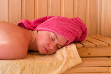 beautiful young woman is relaxing in sauna
