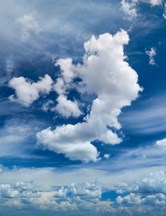 Obraz premium blue summer sky with bright clouds. vertical