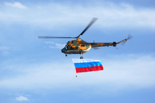 military helicopter flying with Russian Federation flag