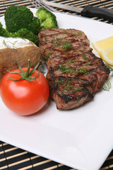 Grilled steak dinner with potato, and vegetables
