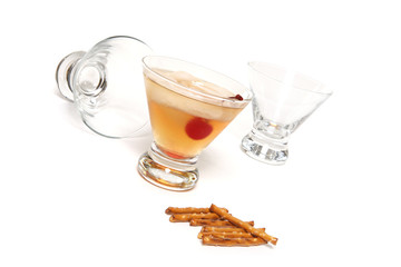 Scotch glasses with pretzels over a white background