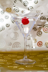 Martini in a glass on a gold background