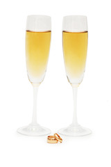 Two wine glasses and wedding rings isolated