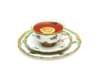 Tea with lemon and saucers isolated on the white