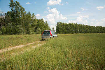 The modern car on earth road a sunny day