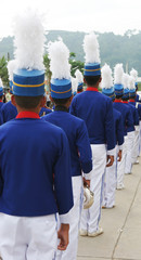 Marching band members in blue and white uniforms