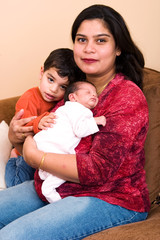 An East-Indian woman poses with her son and daughter