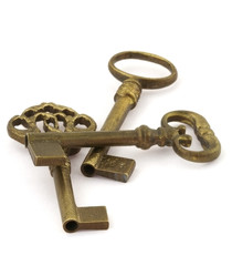 close-up of three ornamented old keys on white background
