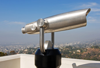 coin operated telescope overlooking city