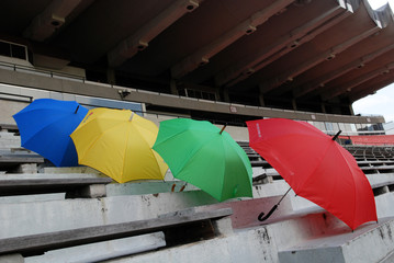 Colorful umbrellas on the stadium seats