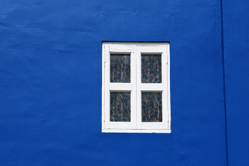 white window and blue walls