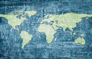 Green world map on blue grunge background