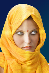 attactive and strong eyes behind an orange scarf 
