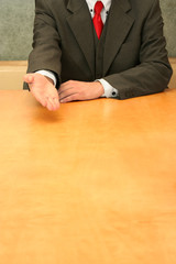 Business-man sitting at the desk, talking about something.