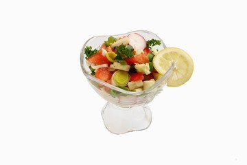 glass dish with vegetables on white background and lemon