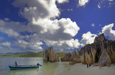 Tourists relaxing on Cousin island beach, Seychelles