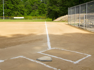 Home plate and first base foul line on a small-town ball diamond